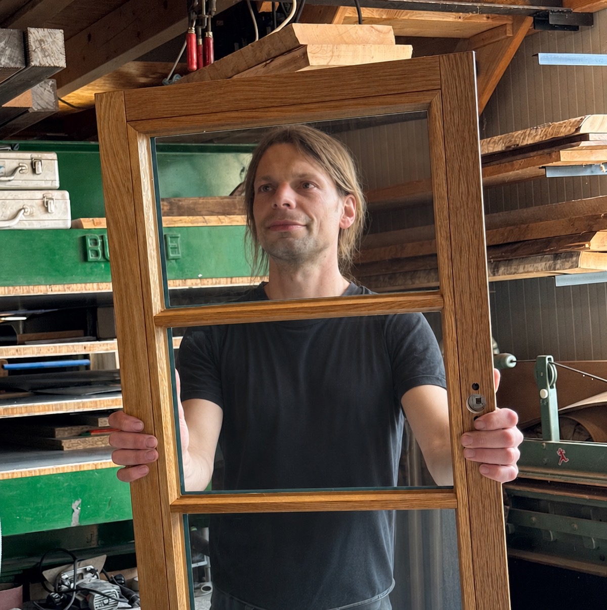 Sebastian Sudhoff bei der Qualitätskontrolle eines Holzfensters
